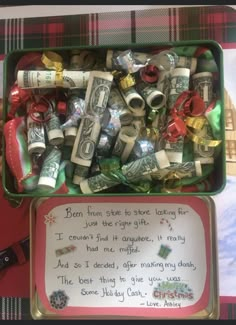 a box filled with lots of money sitting on top of a table next to a sign