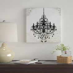 a chandelier hanging on the wall above a table