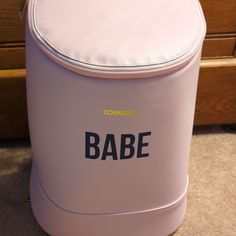 a pink cooler with the word babe written on it