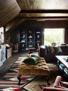 a living room filled with lots of furniture and decor on top of a wooden floor