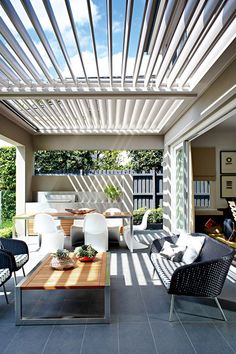 an outdoor living area with furniture and plants