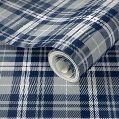 a blue and white checkered tie laying on top of a roll of toilet paper