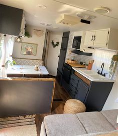 the interior of a mobile home kitchen and living room