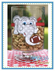 an elephant with a football on it's head is sitting in a glass bowl filled with peanuts