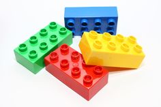 four lego blocks are arranged in a row