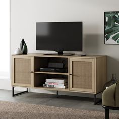 a flat screen tv sitting on top of a wooden cabinet