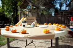 a table with pumpkins sitting on top of it