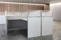 an office cubicle with three partitions on the wall