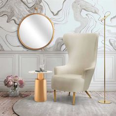 a white chair sitting next to a table with a mirror on it's wall