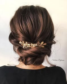 a woman is wearing a gold hair comb