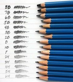 several pencils lined up next to each other on top of a piece of paper