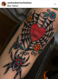 a tattoo on the arm of a woman with a heart and spiderweaver