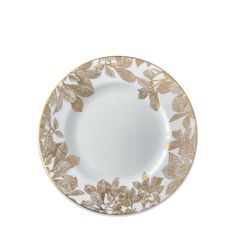 a white and gold plate with leaves on it