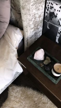 a tray with rocks and candles on it