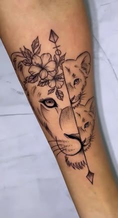 a woman's arm with a lion and arrow tattoo on it