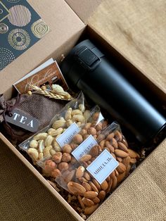 an open box with nuts and tea in it