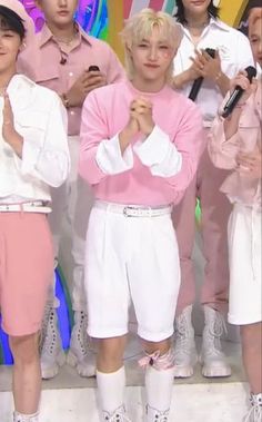 the group of young men are posing for a photo together in pink and white outfits