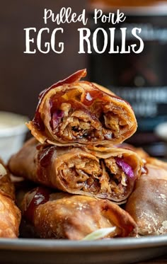 an egg roll stacked on top of each other with the words pulled pork egg rolls