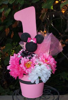 a pink flower pot with minnie mouse ears on it