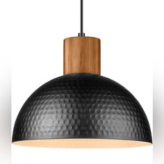 a black and wood pendant light hanging from a ceiling