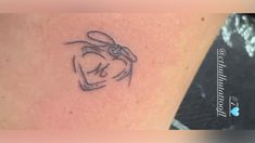 a small tattoo on the back of a woman's left arm, with an outline of a rabbit