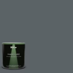 a can of behr marquee paint on a green background