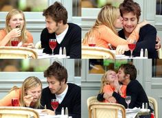 a man and woman sitting at a table with wine glasses in front of their faces