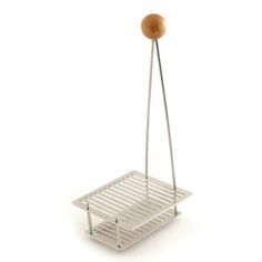 a metal rack with a wooden ball hanging from it's side on a white background