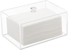 a white tissue dispenser in a clear plastic container with a diamond ring on top