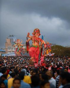 a large group of people standing around an elephant