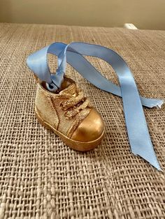 "This is a handmade Children Toddler Baby Boy Sneaker Show Christmas Ornament. The ornament is painted with gold leaf. Comes with a 1/2\" blue ribbon to attach to the tree but I can replace with another color ribbon if you prefer. The ornament measures about 2\" wide x 2\" high. Would make a beautiful and chic gift for any child!!" Baby Boy Sneakers, Boy Toddler, Gold Leaf Painting, Toddler Boy Shoes, Chic Gifts, Boys Sneakers, Christmas Tree Ornament, Blue Ribbon, Toddler Shoes