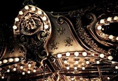 an ornate light fixture with many lights on it's sides and the top part of its head