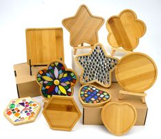 a group of wooden boxes with different designs on them and one has a glass star in the middle