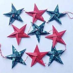 several red and green paper stars are arranged together