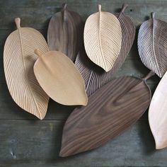 several wooden leaves are arranged on a table