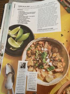 a recipe book with an image of food in it and some spoons on the table