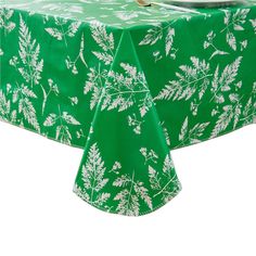 a green table cloth with white leaves on it