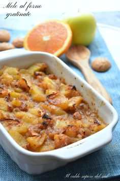 a casserole dish with oranges and nuts in it on a blue towel