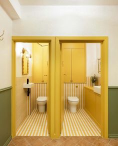 there are two toilets in this bathroom with yellow walls and floor tiles on the wall