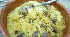 a brown bowl filled with rice and mushrooms