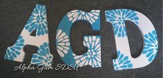 the letters are decorated with blue and white flowers