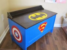 a child's toy chest with batman and captain america decals