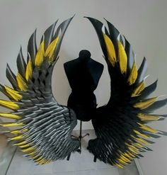 a mannequin with yellow and black wings on it