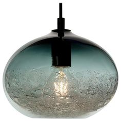 a glass light hanging from a ceiling fixture