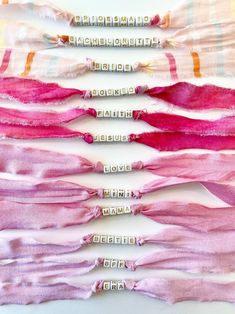 five different colored scarves laid out on top of each other, with the words written across them