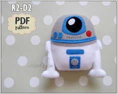 a stuffed toy robot is sitting on a polka dot background with the text, r2 - d2 pattern