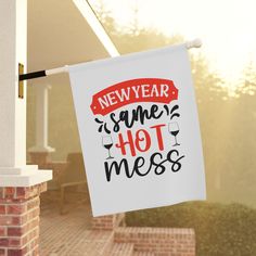 a sign hanging from the side of a building that says new year same hot mess