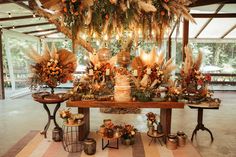 a table topped with lots of flowers and candles