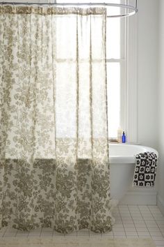 a bath room with a tub and a shower curtain