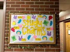 a sign that says study charms hanging on a brick wall